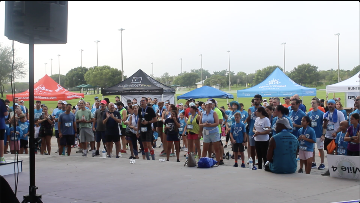 People gather as placement winners collect their medals at the Parkland Dash. The Parkland Dash was an event to raise money for children in foster care.