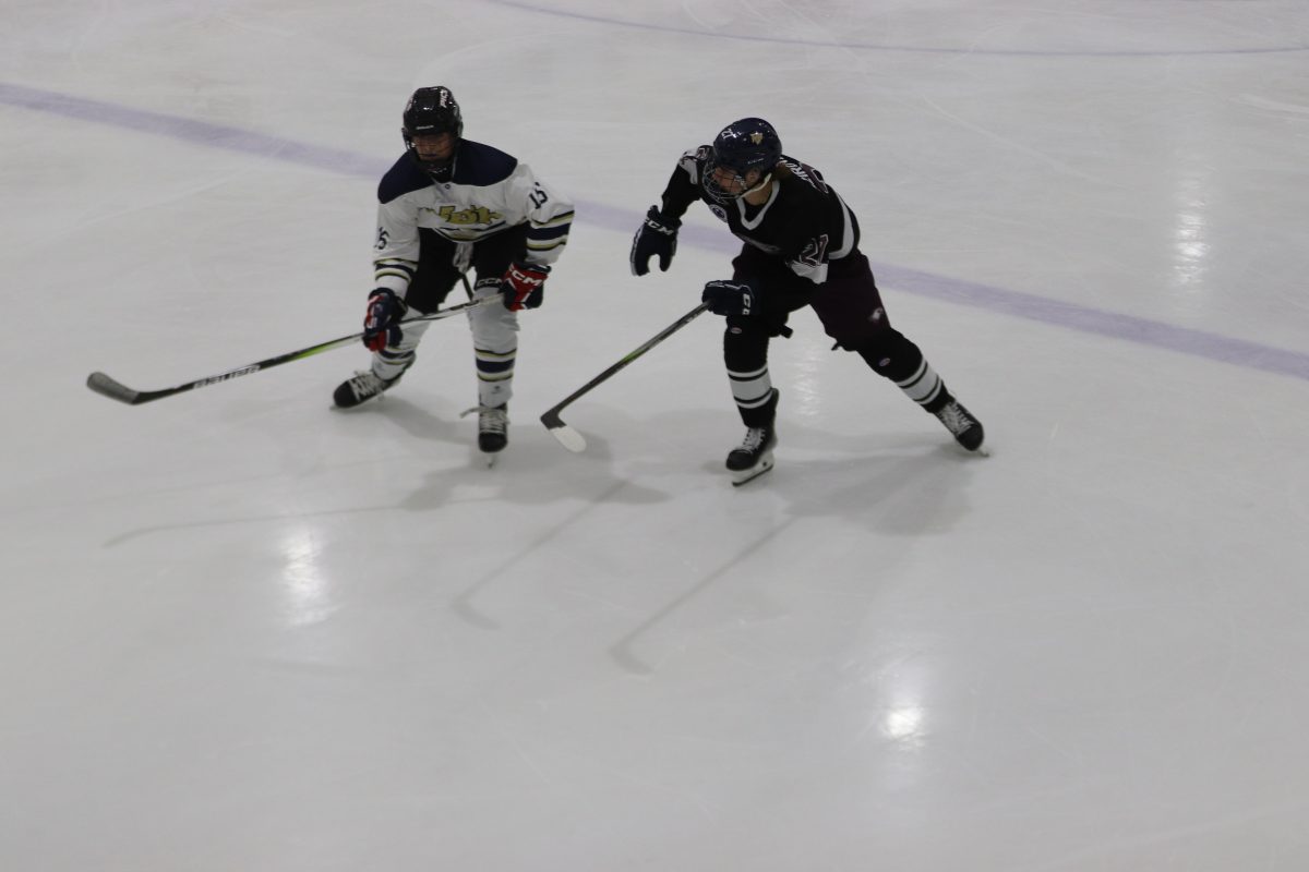 MSD varsity hockey club fights for the puck against North Broward Prep school. This was the Eagles first game of the season and was held at the Panthers Ice Den.