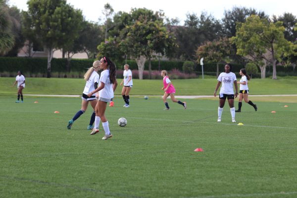 Students practice the rondo drill during tryout, where a player in the middle attempts to make passes in between gaps. Girls soccer tryouts were held at Pine Trails Park the week of Oct. 16-20.