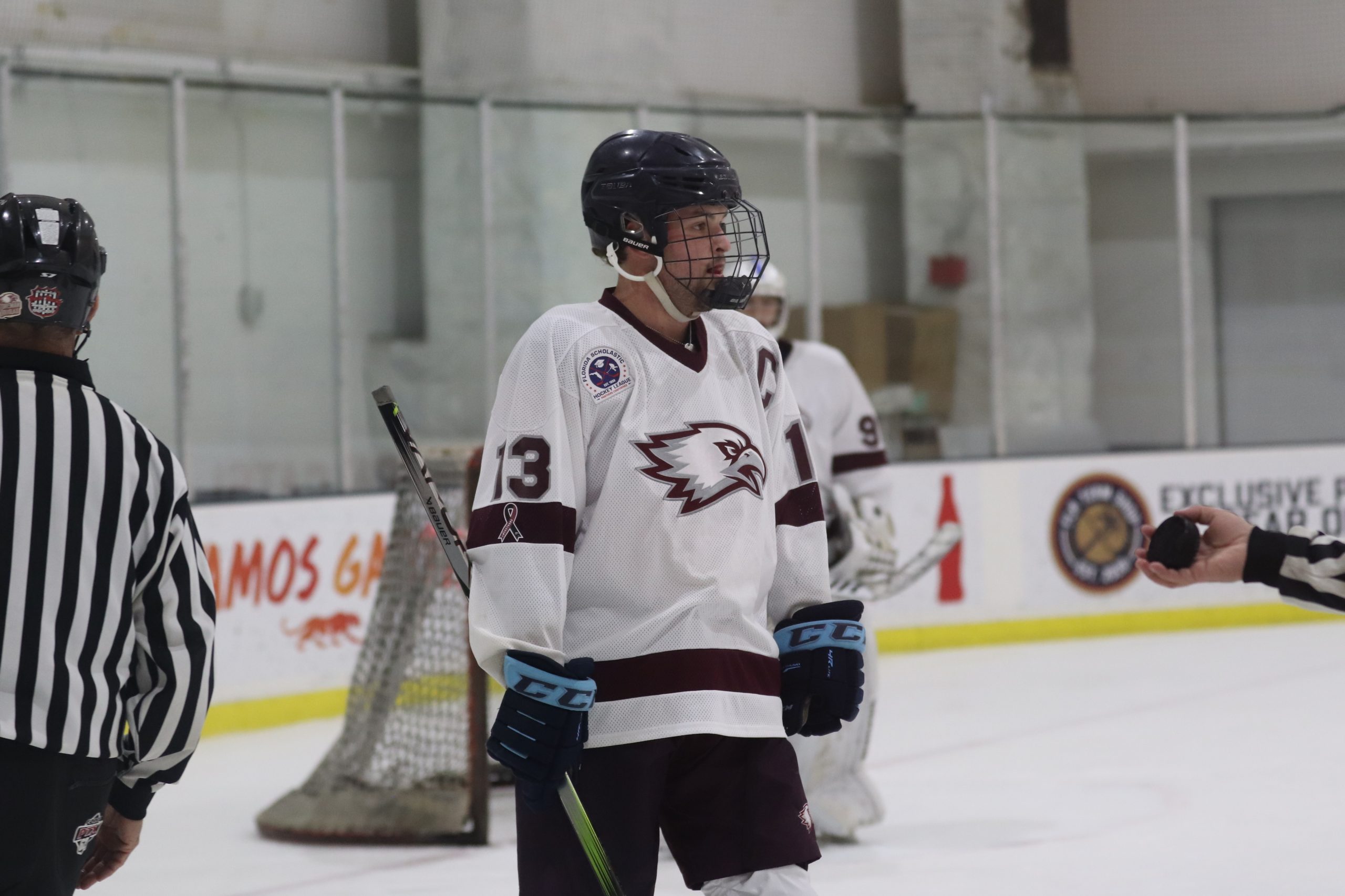Forward Luke Colton (13) prepares for face off against North Broward Preparatory School. The game took place on Nov. 27 at the Panthers Ice Den.