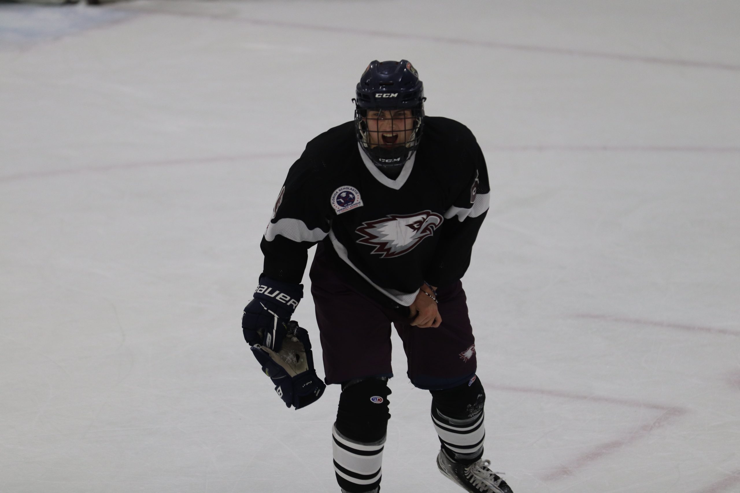 Defenseman Luke Mowery (6) takes off his glove as he steps off the ice after being hit by a player on Cypress. The outcome of the game was a loss with a score of 5-4.