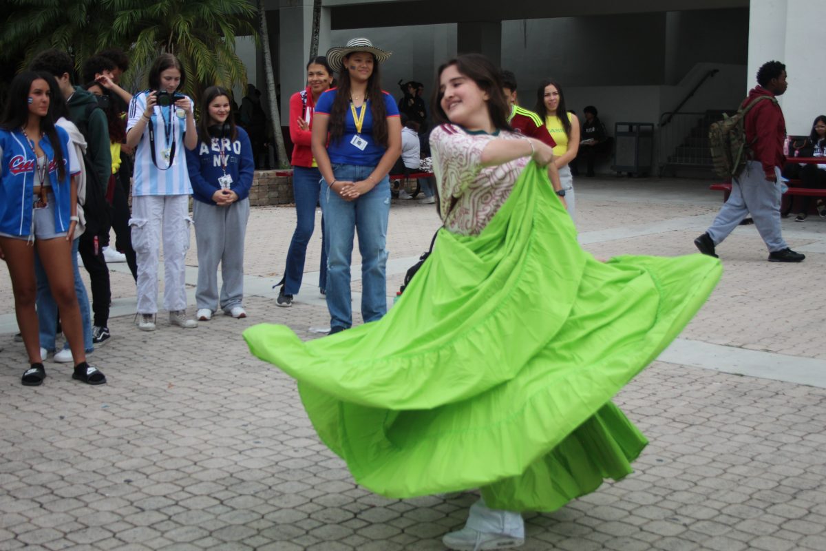 Twirl+and+Swirl.+Senior+Paola+Gutierrez+dazzles+the+crowd+as+she+performs+a+traditional+dance+of+Mexico.+On+Nov.+29%2C+the+Welcome+to+America+club+hosted+an+event+that+celebrated+Universal+Culture+which+featured+activities+such+as+face+painting%2C+music+and+dancing.
