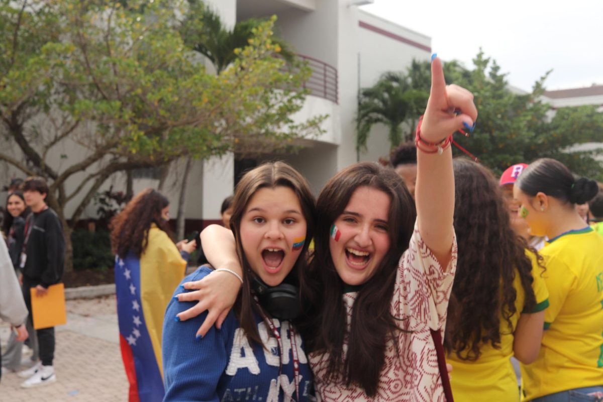 Cheering On Our Nations. Junior Sara Calderon and senior Paola Ulli excidedly sing along to the latin music playing during lunch. The WTA club played music from a playlist that was carefully curated to represent over 150 students home countries. 