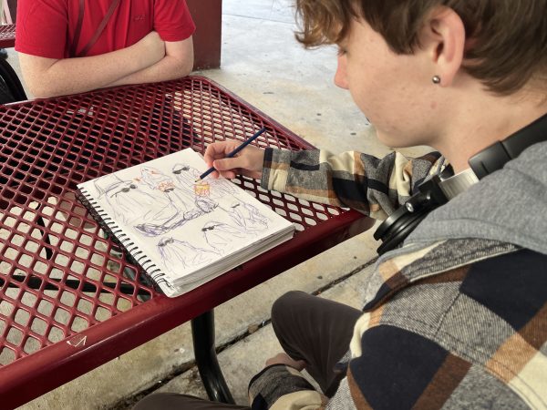 Sophomore Benjamin Goldstein works on his latest colored pencil sketch during A lunch. This piece was part of a larger portfolio he made for both his art class and his own enjoyment.