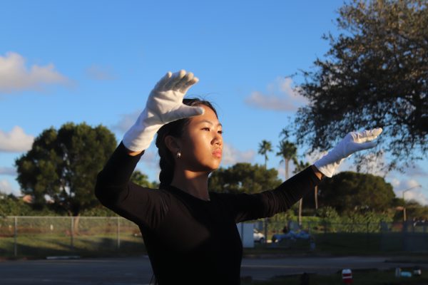 Follow the Leader. Drum Major Bella Wong conducts the marching band at rehearsals after school in the senior parking lot. The band rehearsed outside for four hours to ensure that they were prepared to perform in the Macys Thanksgiving Day Parade.