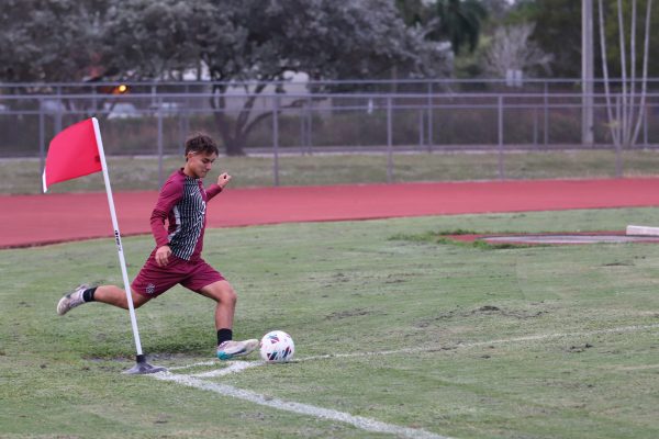 Midfielder Sebastian Piccone (2) takes a corner kick to get the Eagles in a tie against Coral Glades High School to score the last goal of the game. The Eagles ended in a tie of 2-2.