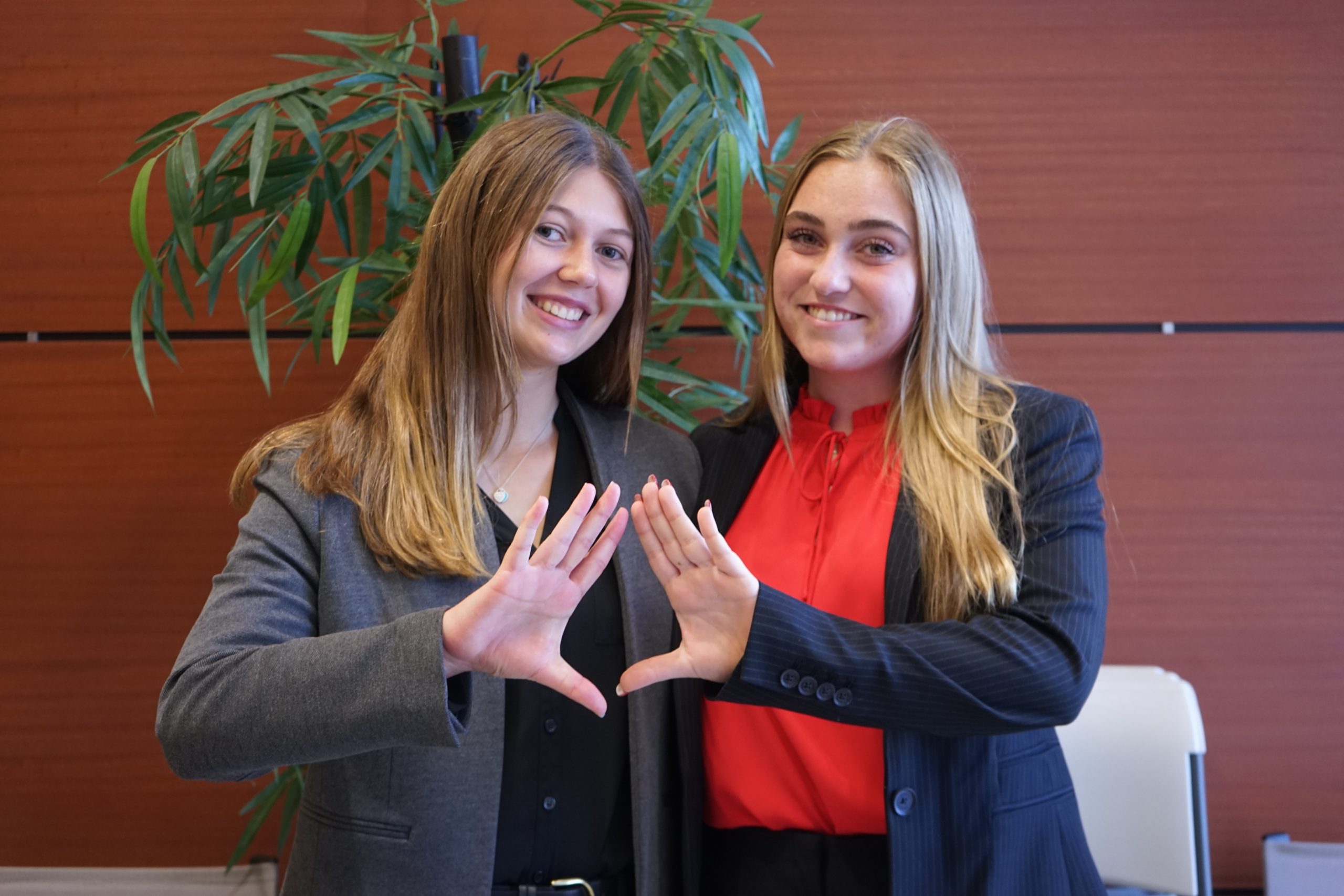 (left to right) Seniors Stephanie Bilsky and Gracyn Haynes sport the DECA symbol, a triangle, at their first career fair, hosted on Dec. 6, 2023. The career fair had 12 business for students to explore and ask questions about. What we wanted to do is just take what weve learned [in DECA] and expand it to those students who arent enrolled in this class and dont have access and then just kind of take it to the community and allow students to discover their future as well, Haynes said.