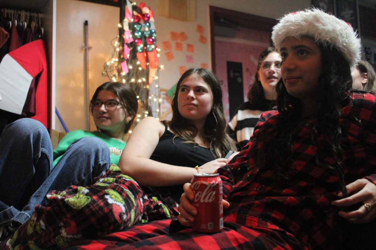 While students were performing, senior Liza Zand, junior Alanis DeSouza and senior Christina Garofalo were able to watch comfortably on a couch that assisted forming a makeshift stage at the Drama Coffee House on Dec 15. Many, along with these students, were able to watch others perform. We all love performing, DeSouza said. Having events like the coffee house truly make us all bond and have fun doing what we love.