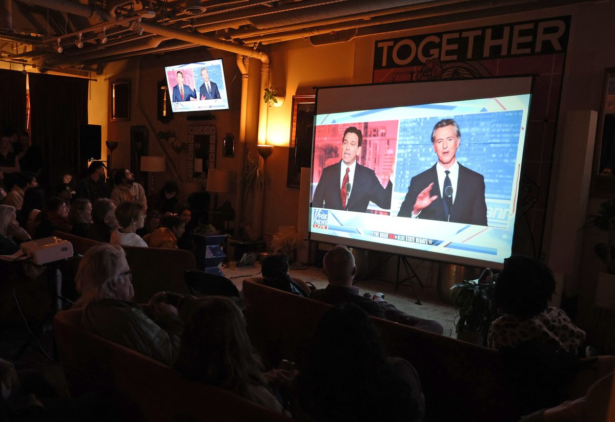 People watch a debate between California Gov. Gavin Newsom and Florida Gov. Ron DeSantis during a watch party at Mannys on November 30, 2023 in San Francisco, California. Newsom and DeSantis were hosted by Sean Hannity on Fox. Photo permission from Justin Sullivan/Getty Images/TNS.