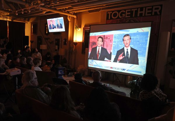 People watch a debate between California Gov. Gavin Newsom and Florida Gov. Ron DeSantis during a watch party at Mannys on November 30, 2023 in San Francisco, California. Newsom and DeSantis were hosted by Sean Hannity on Fox. Photo permission from Justin Sullivan/Getty Images/TNS.