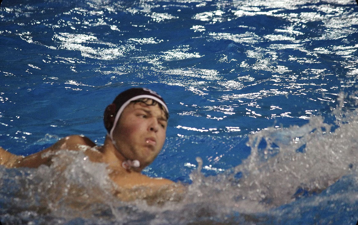 Center defender Austin McClellan swims towards the opposing team to move the ball down the pool. McClellan has been playing waterpolo since he was little and plans to continue playing the future.