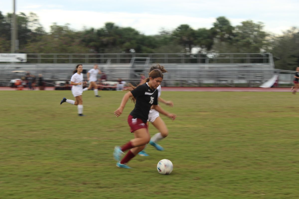 Fancy+footwork.+Center+Midfielder+Samantha+Arias+evades+the+defense+down+the+field%2C+passing+the+ball+to+Forward+Bree+McWilliams+to+tie+the+games+score.+This+goal+took+place+at++the+JV+girls+soccer+game+against+the+St.+Thomas+Aquinas+High+School+Raiders+on+Jan.+16+at+the+Cumber+Stadium.+The+game+ended+in+a+tie%2C+with+a+score+of+1-1.+%E2%80%9CI+think+the+game+went+well%2C+but+the+first+half+was+kind+of+slow%2C+Arias+said.+We+could+have+done+a+lot+better%2C+but+in+the+second+half+we+really+kicked+it+up.