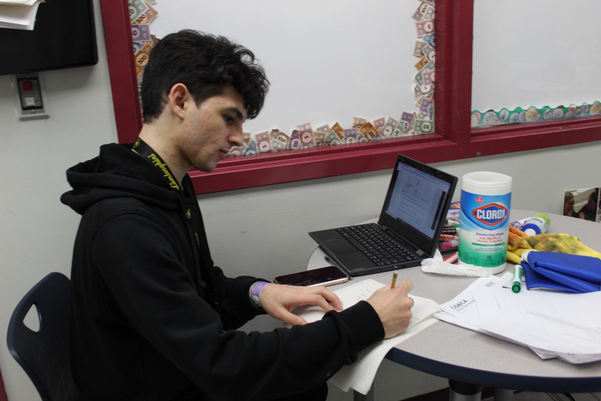 Junior Sebastian Bagoon prepares for DECA States competition on Feb. 15. After school, Bagoon practiced his roleplay for upcoming DECA states competition in Orlando, Florida.
