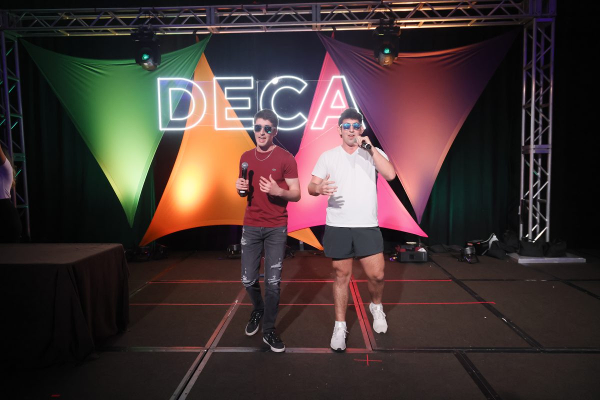 MSD DECA competitors and seniors Luke Shay and Jonah Strachman sing on stage at the Florida DECA karaoke night on Friday, March 1. Florida DECA attendees were able to attend the karaoke night for free or the silent disco at a $15 fee. Photo permission from Eric Garner.