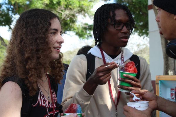 Enjoying their snow cones, junior Heidi Dumke, junior Aydin Blake and senior Josiah Jimenez meet after school in the senior parking lot on March 5. TV Club held a fundraiser with Kona Ice to raise money for the them to purchase film equipment and for the clubs productions.