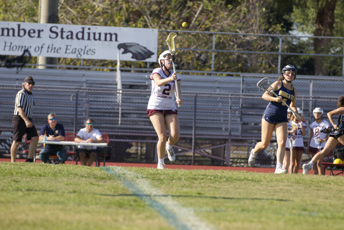 Superb Catch. Midfielder Gracyn Haynes (2) reaches her lacrosse stick out to catch the ball mid-air. The Lady Eagles won 16-6 over the Bobcats.