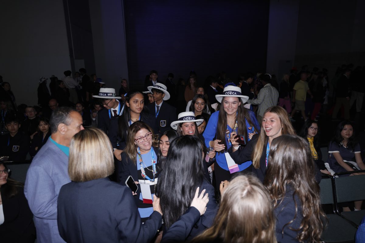 MSD DECA competitors and advisors crowd around and congratulate seniors Aneesha Nookala and Ananyaa Sutaria for winning first place in the Business Solutions Competitive Event. The top ten finalists for each DECA competition were announced during the closing ceremony on Tuesday, April 30. Photo permission from Eric Garner.