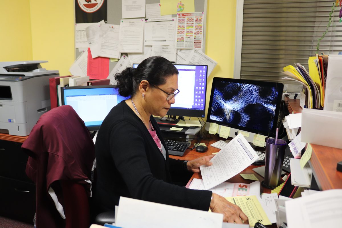 Bookkeeper Lisa Morales reviews project approval forms in her office on Sept 18. The school staff selected Morales to represent MSD as the Non-Instructional Employee of the Year for 2024.