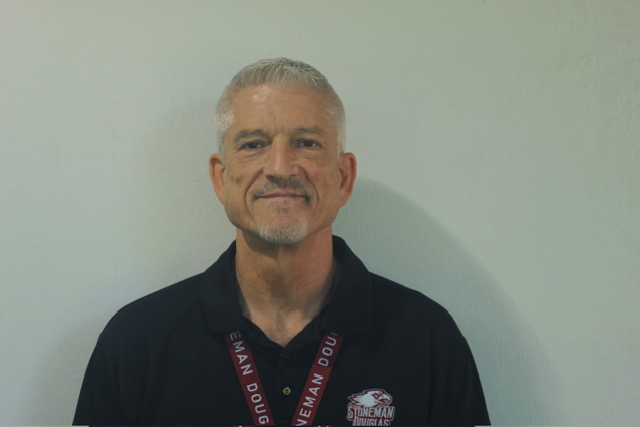 Math teacher Jeffrey Taylor poses for the camera. He was formerly a flight attendant before returning as a math teacher.