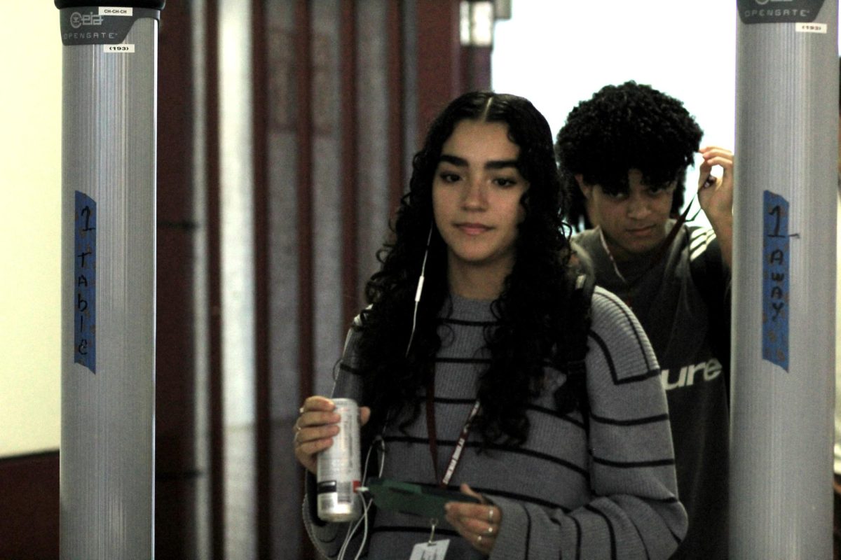 Pedal to the Metal. Walking into school from the bus loop entrance, senior Mariana Giraldo passes through the mandatory metal detector screening at MSD on Sept. 24. Broward County Public Schools passed a new policy requiring all students to pass through metal detectors that went into effect on Aug. 12. “I think they are pointless since they don’t really go off for everything,” Giraldo said. “You can have a big water bottle, and it doesn’t detect it. I feel like it misses things and is a waste of time.”