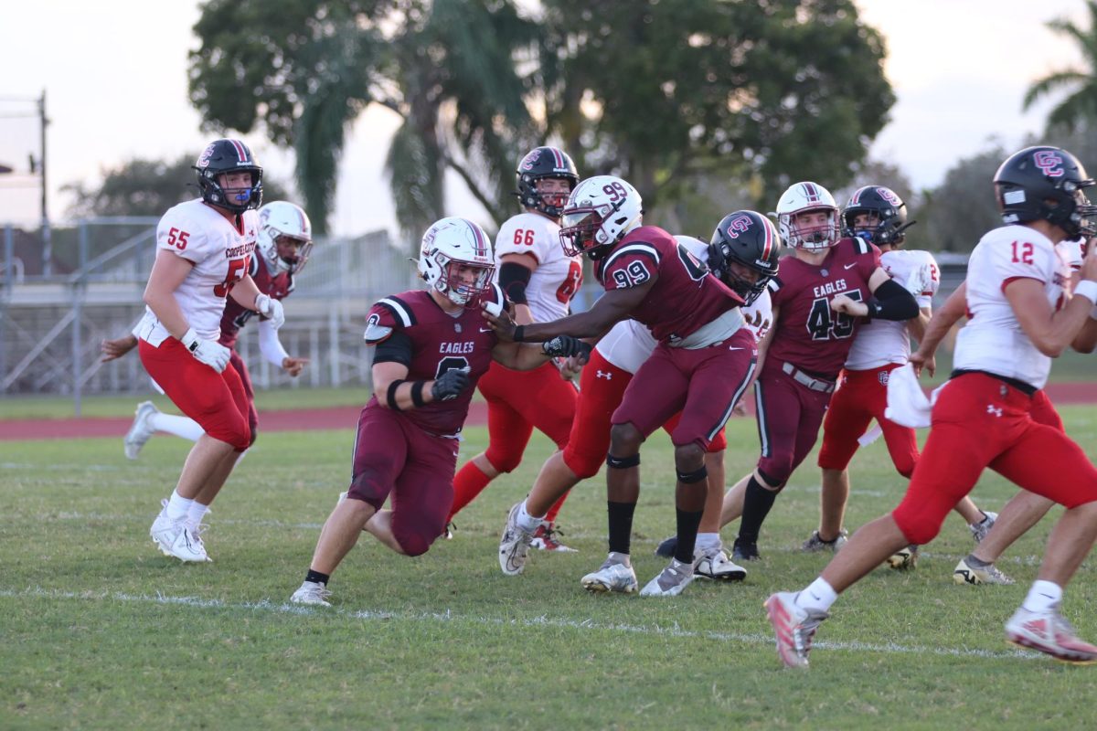 Eagles cornerback Christopher Jackson (6) blitzes to tackle the quarterback of the Cowboys. The Eagles scored a touchdown late in the fourth quarter of their Sept. 30 game, during their last offensive series against Cooper City High School.