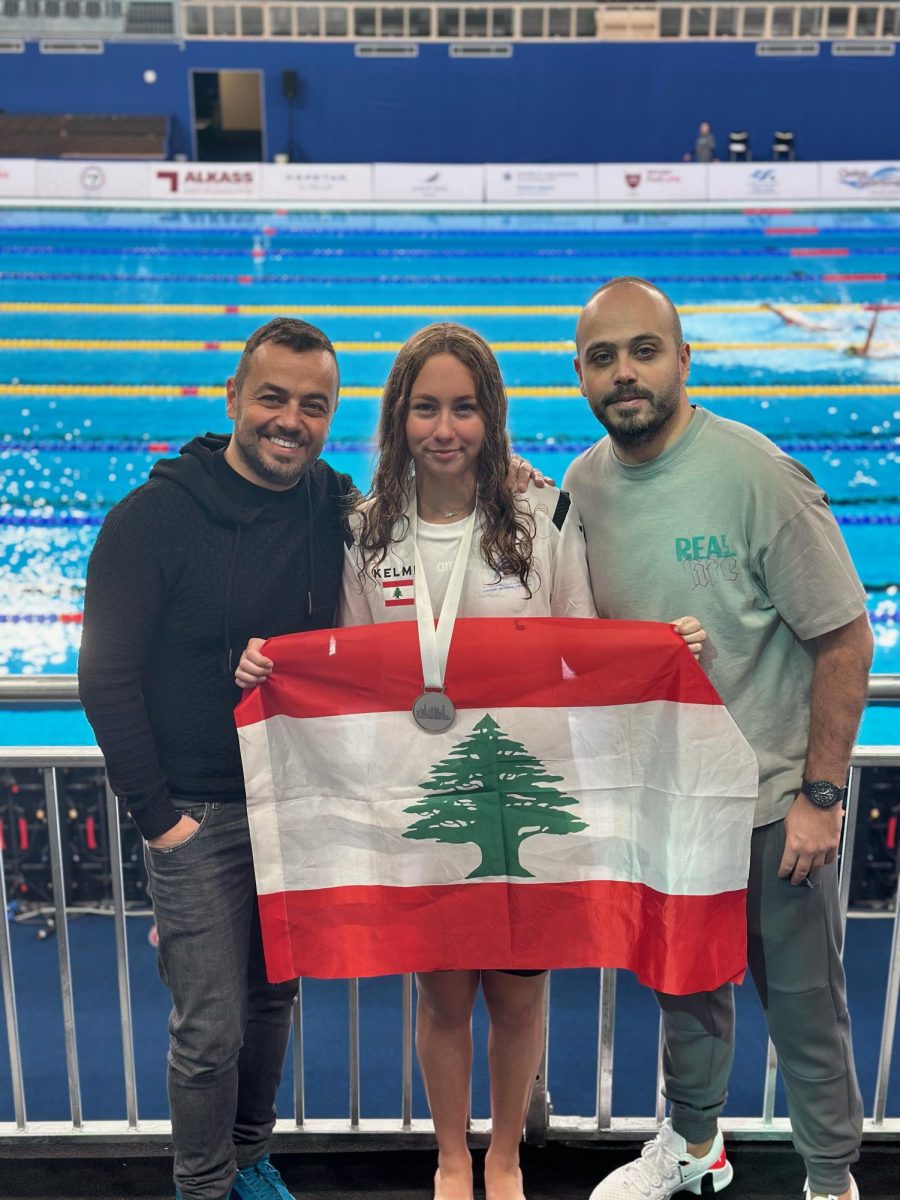 Swim team captain Sophia El Chantiry presents a silver medal and the Lebanese flag with her father and uncle. El Chantiry earned the medal at the third Arab Aquatics Championships on Aug. 25-28, held at Cairo, Egypt. In the competition, El Chantiry would place second in girl's 50-meter Butterfly Swimming, representing her home country Lebanon.