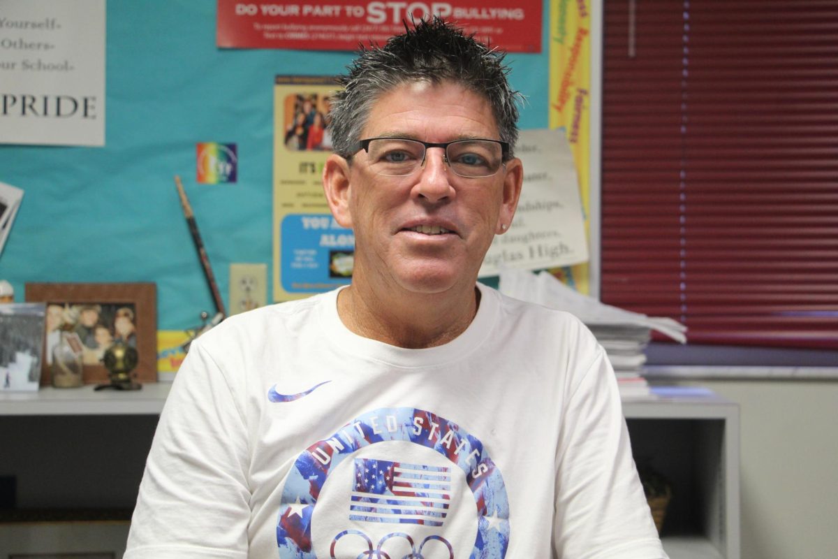 Guidance counselor Jerry Turmaine poses in his office. On the side, Turmaine is a band member and scuba instructor.