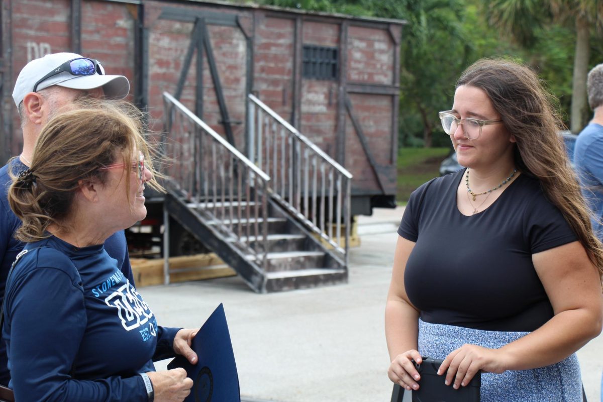 DECA advisor Sharon Cutler starts a conversation with ShadowLight Educator Jori Reiken after signing in to the Hate Ends Now Cattle Car Exhibit on Dec. 15 outside of the Parkland Public Library. DECA chapter project We Remember co-founders Ethan Klein and Mallory Biederman played a large role in making the event happen, and many MSD teachers showed up in support of the two and the fight against prejudice, including TV teacher Eric Garner and DECA advisor Lisa Webster. "It's important to learn about the Holocaust because we are bound to repeat history if we don't learn about it," Reiken said.