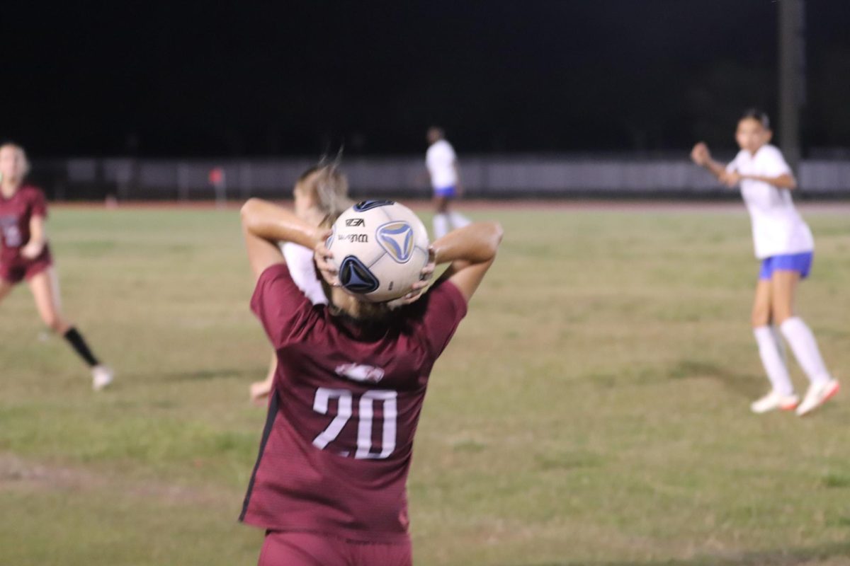 Forward Alessia Frenquelucci takes a throw-in at the game against Cypress Bay on Wednesday, Oct. 13. The Eagles won the game with a score of 1-0. "Before game time, we make sure to hydrate well and get a good warmup in," Centerback Sophia Dal Molin said.