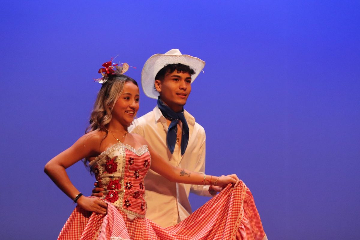 Seniors Luis Silva and Sara Lopez dance during the Sanjuanero performance on Friday, Dec. 6. Silva choreographed bachata and danced in tambores, merengue and Sanjuanero.