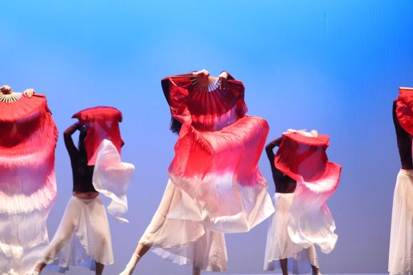 Chinese Traditional dancers gracefully perform the second dance of the show using fans. The dance was the first of two acts sponsored by Asian Student Association, the other being K-pop. 