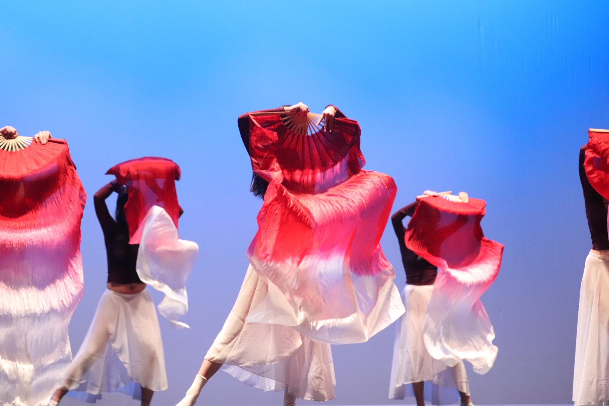 Chinese Traditional dancers gracefully perform the second dance of the show using fans. The dance was the first of two acts sponsored by Asian Student Association, the other being K-pop. 