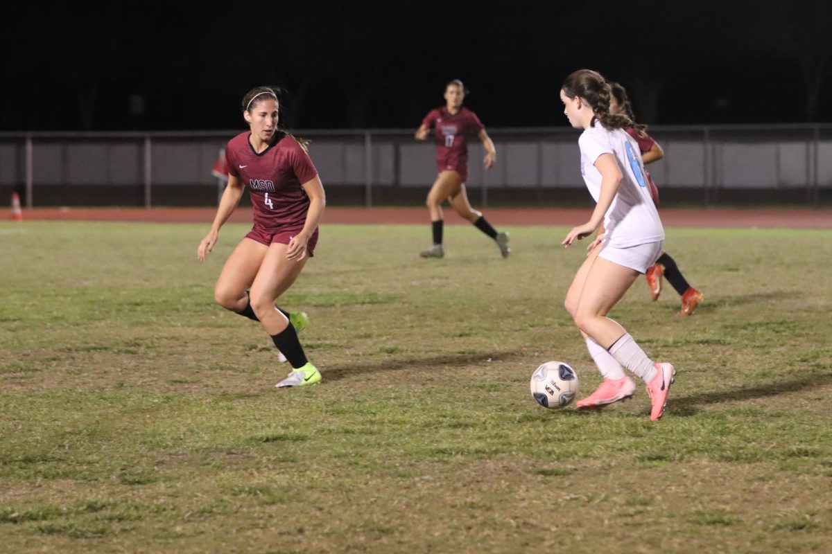 Centerback Sophia Dal Molin (4) eyes the ball that a Lourdes Academy is dribbling. The Lady Eagles ultimately tied with the Ladies of Our Lourdes.