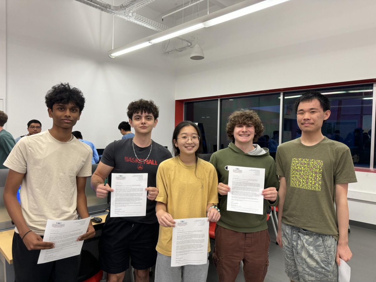 Juniors Eashaan Murthy, Niki Yuan, Alex Freedman, Kevin Liu and senior Ely Herman pose with their certificates from the math competition. Students of math honors society have the choice to compete in state-wide competitions such as this one, which took place on Nov. 12 at the AMC arena.