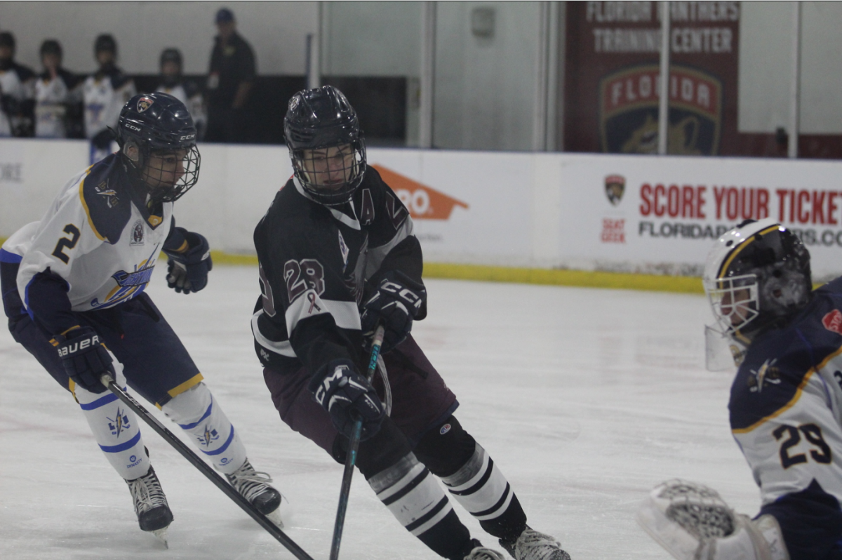 Forward Von Seys (28) sets his sights on the goal as he attempts to score during the Friday, Jan. 10 boys' varsity hockey game against Cypress Bay High School. The Eagles lost, with the game ultimately ending 4-2 in Cypress' favor. "We put the puck in and out a lot as well as we had good energy on the bench," Seys said.