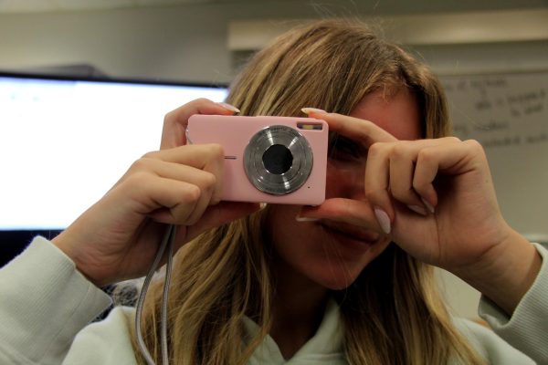 Sophomore Laura Maurer looks through a digital camera; she is one of many MSD students who own one. With the resurgence of digital cameras through social media, their vintage quality and cheap price make them a good camera option. "I prefer digital cameras over my phone camera because the digital camera looks more aesthetic, and the photos always come out looking better," Maurer said.