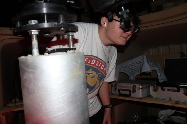 Junior Jacob Constant peers at planets through a telescope. Astronomy Night allowed students from various schools to come and learn about astronomy at MSD.