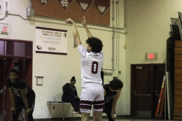 Guard Jacob Rayvis shoots a free throw for the Eagles. On Wednesday, Jan. 22 the men's varsity basketball team played against JP Taravella High School, leading throughout the game and beating them with a score of 68-58.