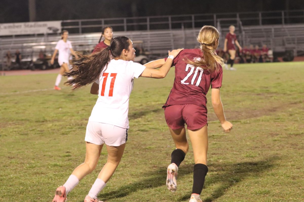 Forward Alessia Frenquellucci (20) competes for the ball against a Doral defense player. MSD varsity women's soccer team beat Doral Academy 4-3 on Tuesday, Feb. 3.