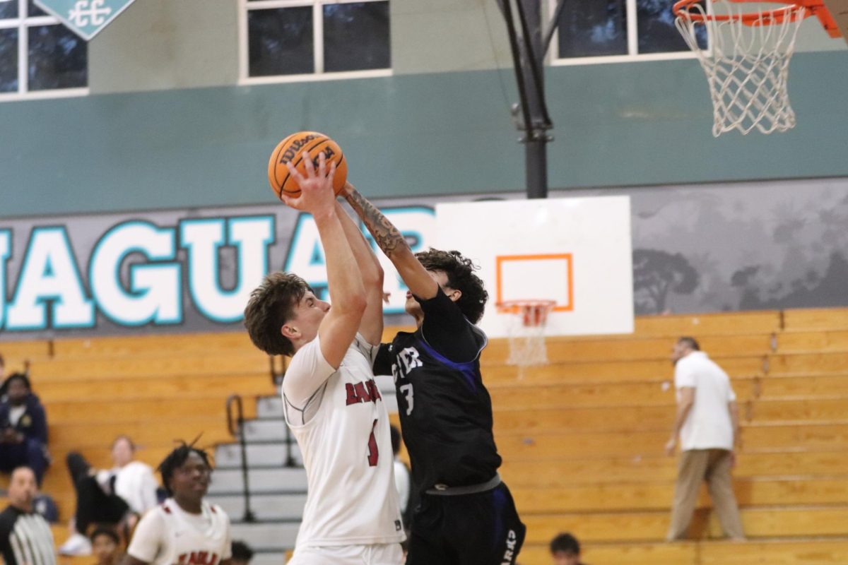 Shooting guard Brady Keubler (1) attempts to make a basket but is blocked by an opponent. MSD men's varsity basketball team played Spanish River High School on Monday, Feb. 3; the game ended in a score of 67-39 in favor of the Eagles, allowing them to pass to the semifinals of the district championships.