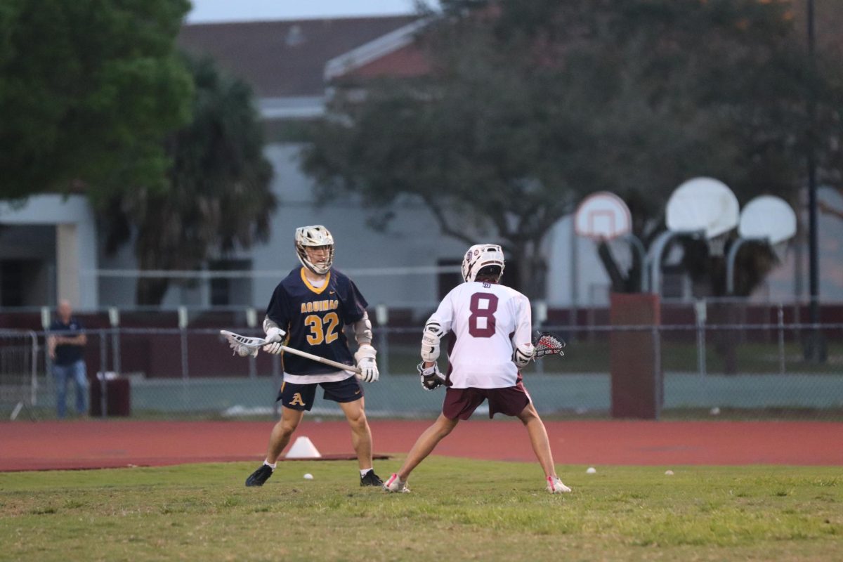 Midfielder Josh Lieberman (8) defends a Raiders attack in the Eagles' home game against St. Thomas Aquinas High School on Tuesday, Feb. 18. The MSD men's varsity lacrosse team was defeated by a score of 0-21.