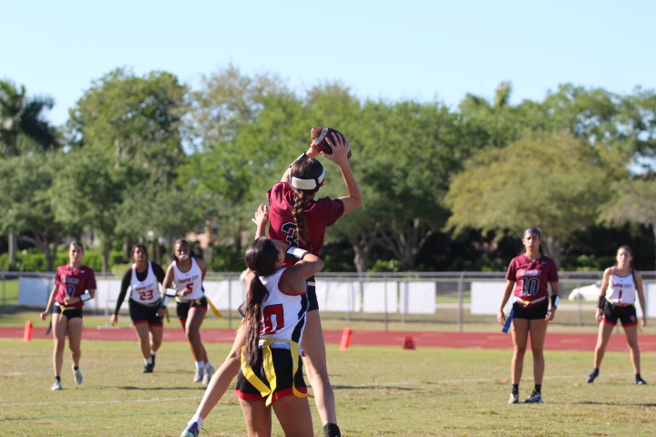 Defensive back and wide receiver Caitlin Taylor (3) intercepts the ball in a game against the Cooper City Cowboys. As a freshman starting on varsity, Taylor also scored a touchdown against the Cowboys. "Warmups for me are really important because it gives me time to practice defense against our offense," Taylor said. "I feel prepared after warming up and it affects the way I play in the game. Warming up gives me confidence and reassures myself that I know everything and I can do everything my team needs me to do."