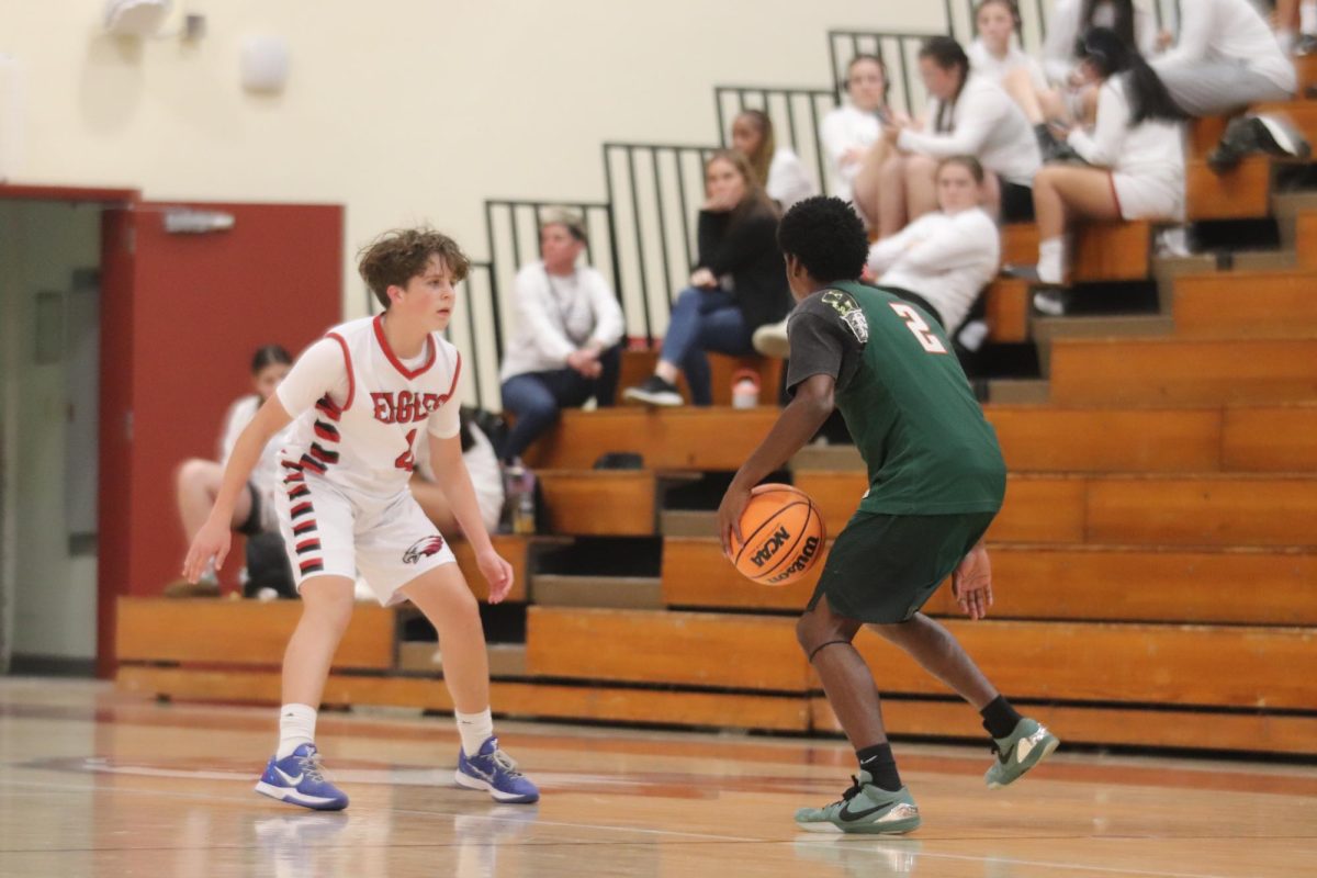 Clamps. Guard Josh Hayes (4) defends the point against MacArthur High School in a home game on Tues., Jan. 13. The game took place at 4:30 p.m., and the team improved to 10-2 on the season after beating MacArthur 61-46.