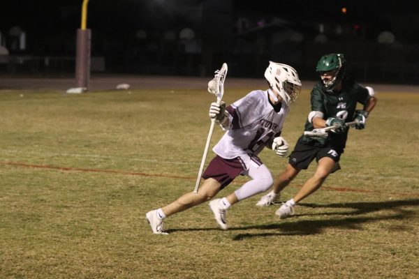 Speed Demon. Midfielder Max Fliegel (18) sprints up field with the ball on the offense against Pine Crest High School on Wed., Feb. 18. The boys varsity lacrosse team dropped to 1-3 on the season following a 4-19 loss to Pine Crest. Fliegel used his speed to keep the ball away from Pine Crest throughout the game, as well as scored the team's first goal of the game. "We moved the ball around very well, however we just had to finish the plays we created and put the ball in the back of the net," Fliegel said.