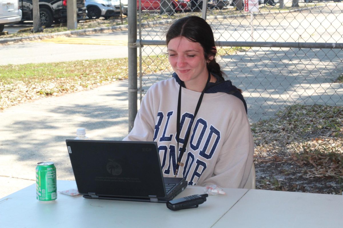 Saving Lives. In the senior lot, junior Addison Miller helps make sure students donating blood get back to class. JROTC held a blood drive in partnership with OneBlood on Tues., Feb. 24. "I enjoy doing the blood drive because donating blood saves people's lives," Miller said.