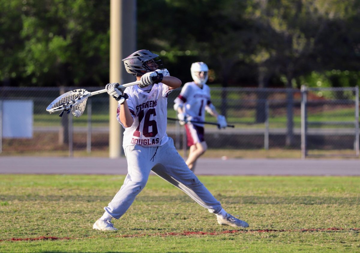 Air It Out. Goalie Matteo Swetsky (16) passes the ball out of the defensive zone against Miami Country Day School on Thurs., March 26. It was a special occasion, as it was Senior Night, where the seniors were honored for their dedication to the men's varsity lacrosse team. "It was pretty sad seeing them [seniors] go," Swetsky said. "I had a lot of fun playing with them and hanging out with them this year."