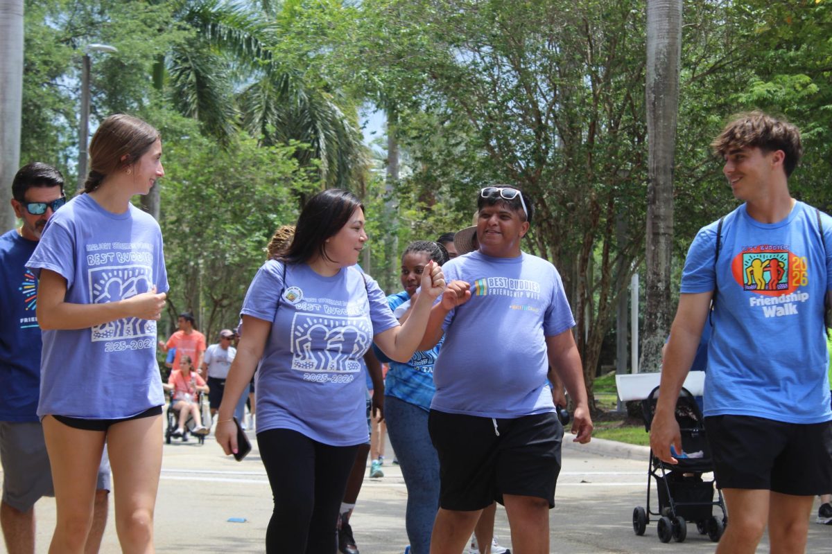 Fist Bump. Junior Morgan McCluskey, club sponsor Coral Bachen, graduate Dean Hassan and junior Griffin Haynes participate in the Best Buddies Walk for students with intellectual and developmental disabilities. On Sun., April 19, the school’s Best Buddies club attended the event at Nova Southeastern University from 12-4 p.m. “The Best Buddies club is the best club I have ever joined,” Hassan said. “The people in Best Buddies make me feel amazing, and all the parties are lots of fun.”